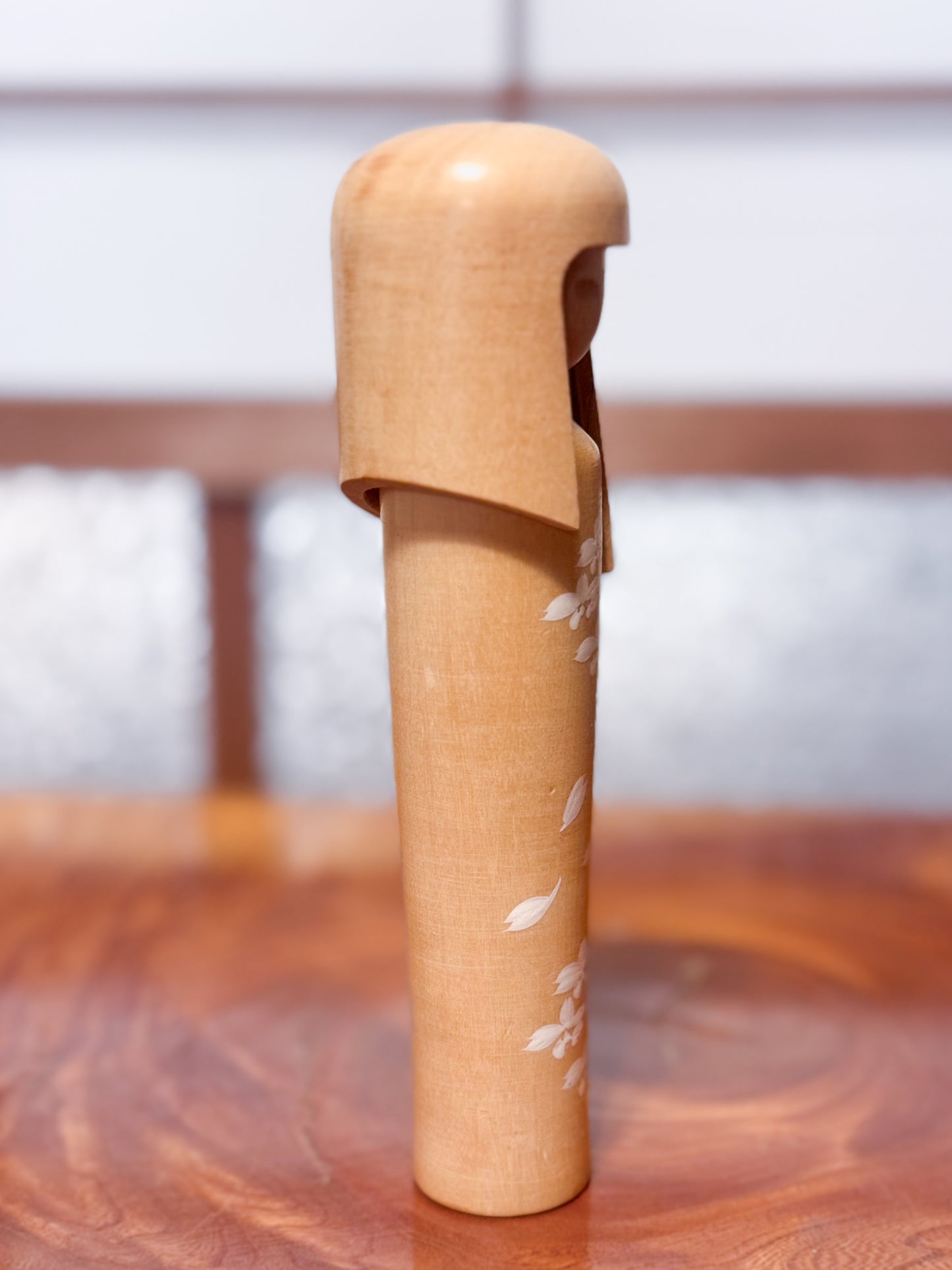 kokeshi de Miyashita Mihutsu en bois naturel avec fleurs blanches peintes et longue chevelure, profil droit