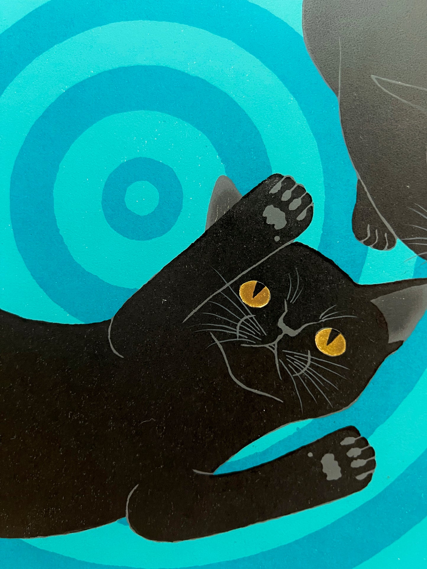 estampe japonaise deux chats noirs sur spirale bleue, dessous des pattes