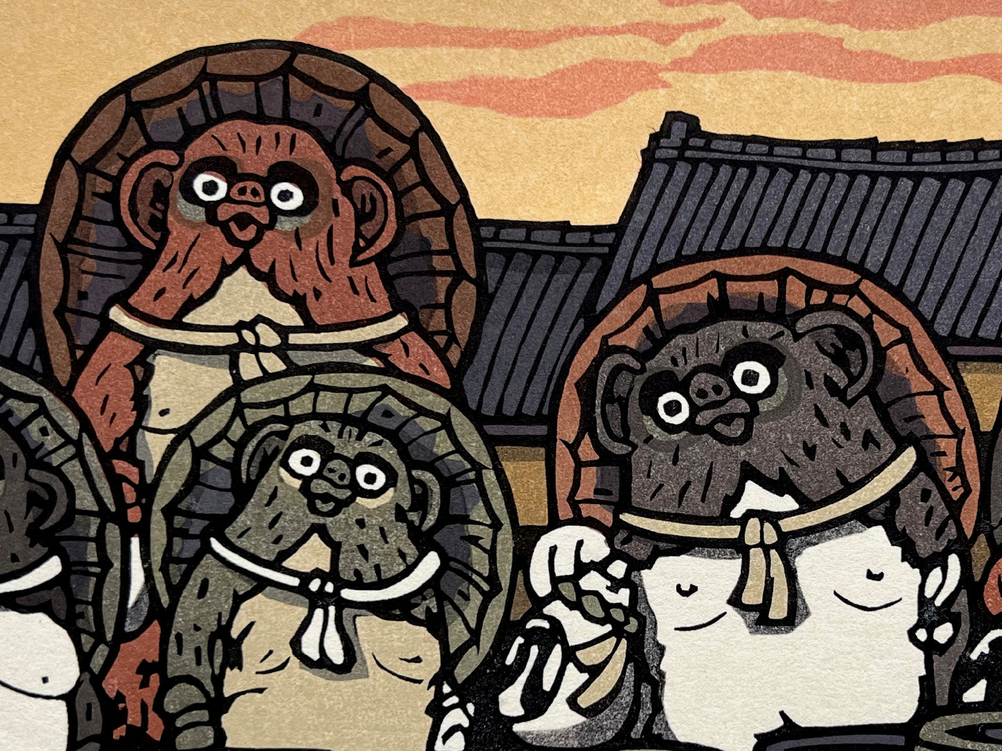 estampe japonaise groupe de tanuki devant des jarres en terre, toit des maisons et ciel jaune orange en arrière plan, gros plan sur les têtes des tanukis portant un chapeau
