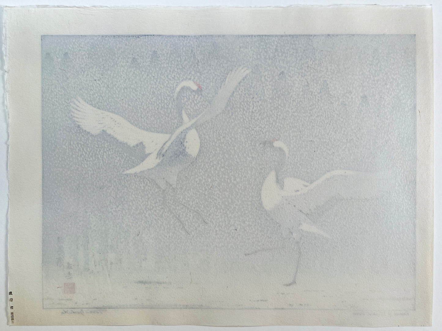 estampe japonaise deux grues du Japon dansent face à face sous la neige, dos de l'estampe