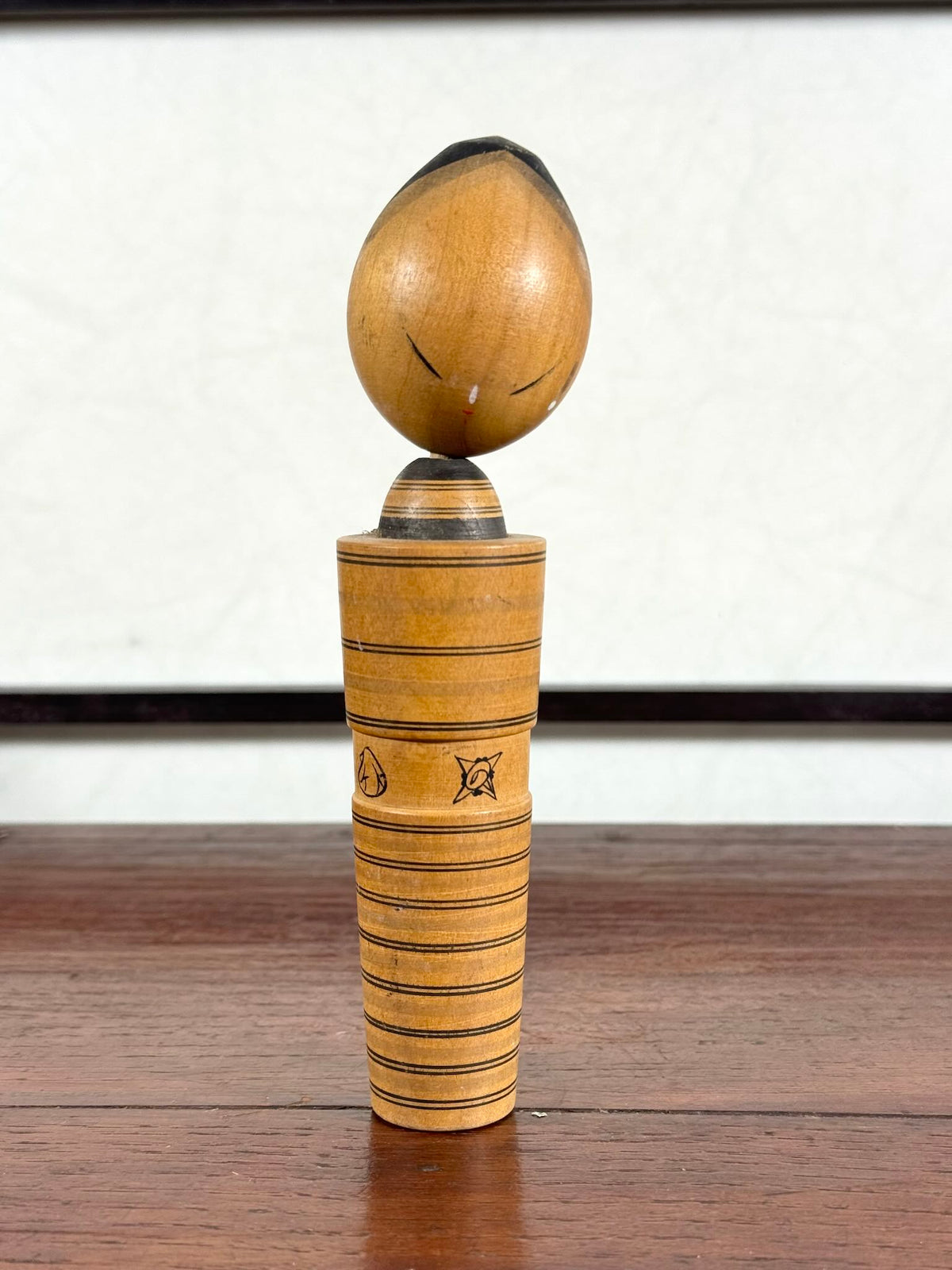 kokeshi de Sato Hatsuro sumi-e motif lignes, crabe et coquillages, vu de face