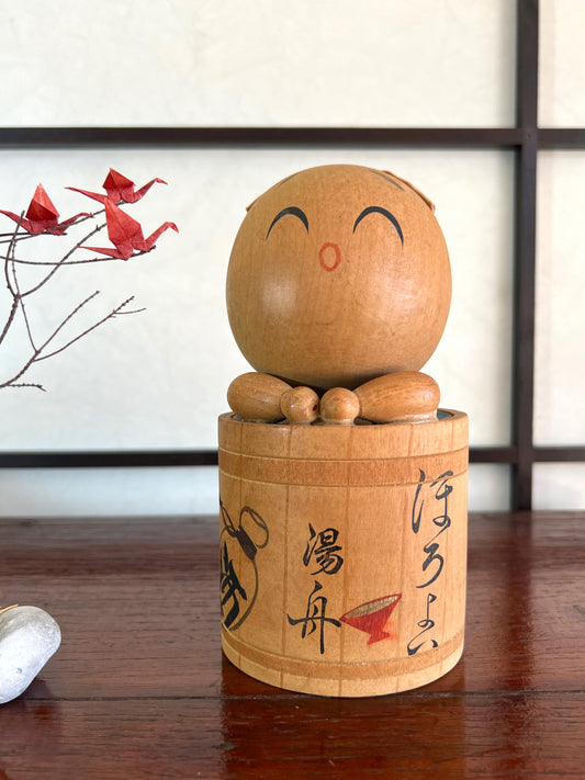 kokeshi poupée japonaise en bois dans son bain
