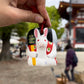 Clochette japonaise en céramique en forme de lapin suspendue par une ficelle rouge 