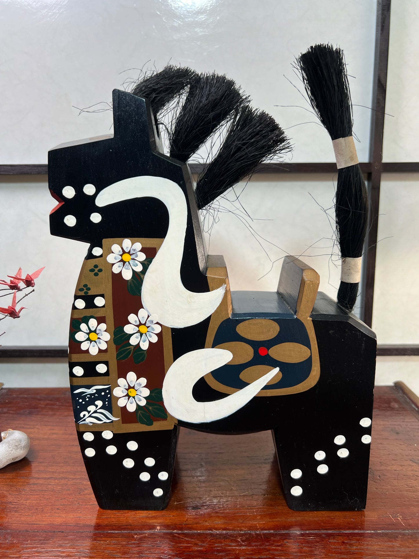 cheval traditionnel japonais en bois noir profil gauche, peintures fleurs et vagues