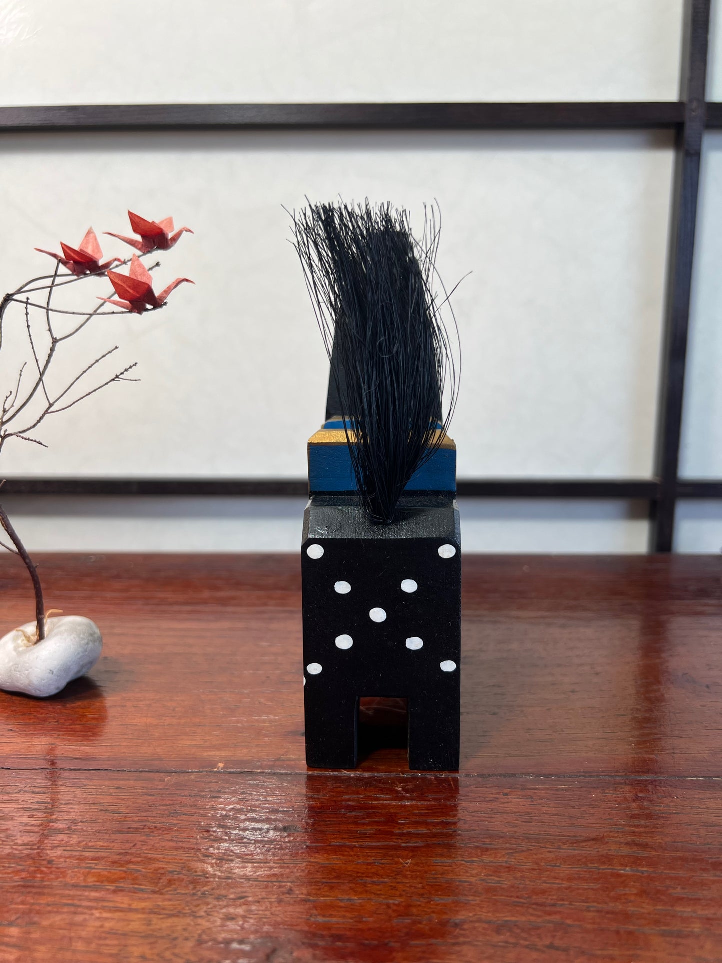 Cheval traditionnel japonais en bois noir de dos, queue relevée 