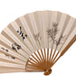 éventail japonais ancien en papier ivoire avec branches de pin et calligraphie noire « matsukaze »