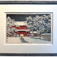 estampe japonaise encadrée la neige tombe la nuit sur le temple rouge