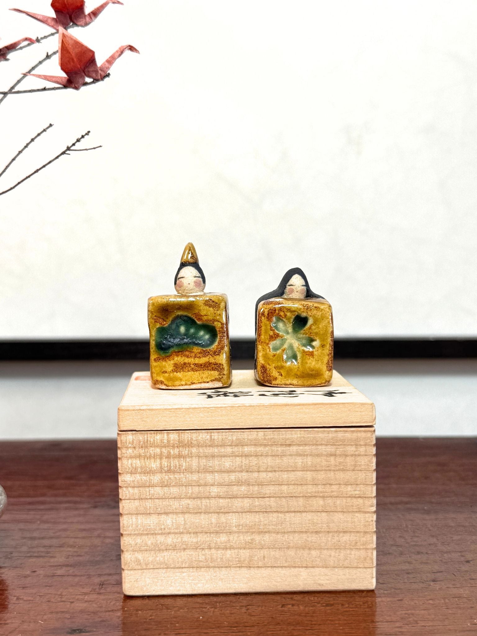 couple de poupées impériales japonaises cubiques en céramique émaillée sur boîte en bois.