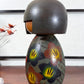 Kokeshi vintage japonaise de Yuji Kawase, au kimono vert orné de fleurs campanules colorées gravées et peintes, période Shōwa, vu du profil gauche