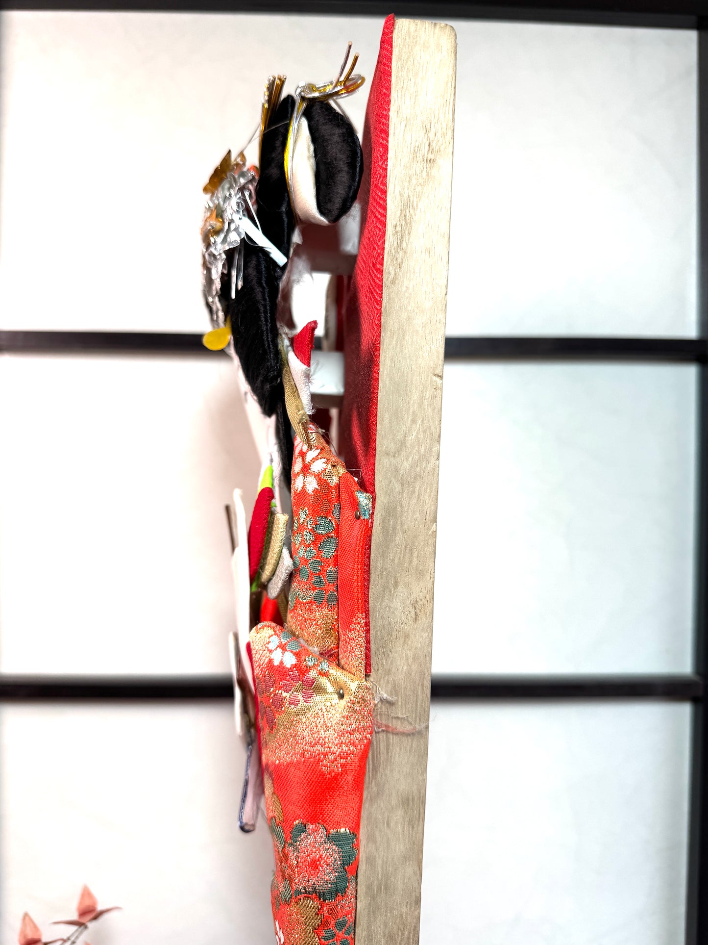 raquette décorative japonaise hagoita, femme tenant une hagoita miniature, motif bambou et prunier en fleur, vu de profil gauche