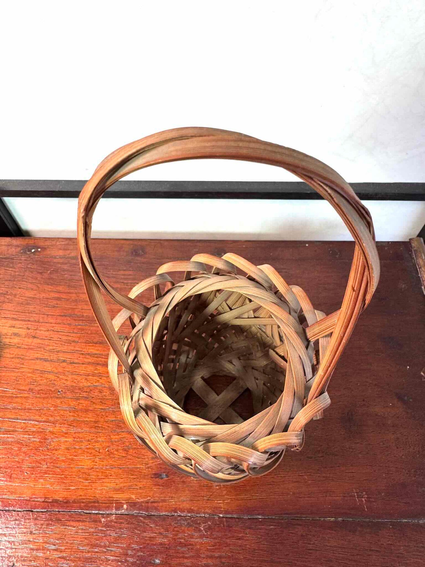 Panier hanakago japonais ancien en bambou tressé avec anse haute, vu dessus avec anse