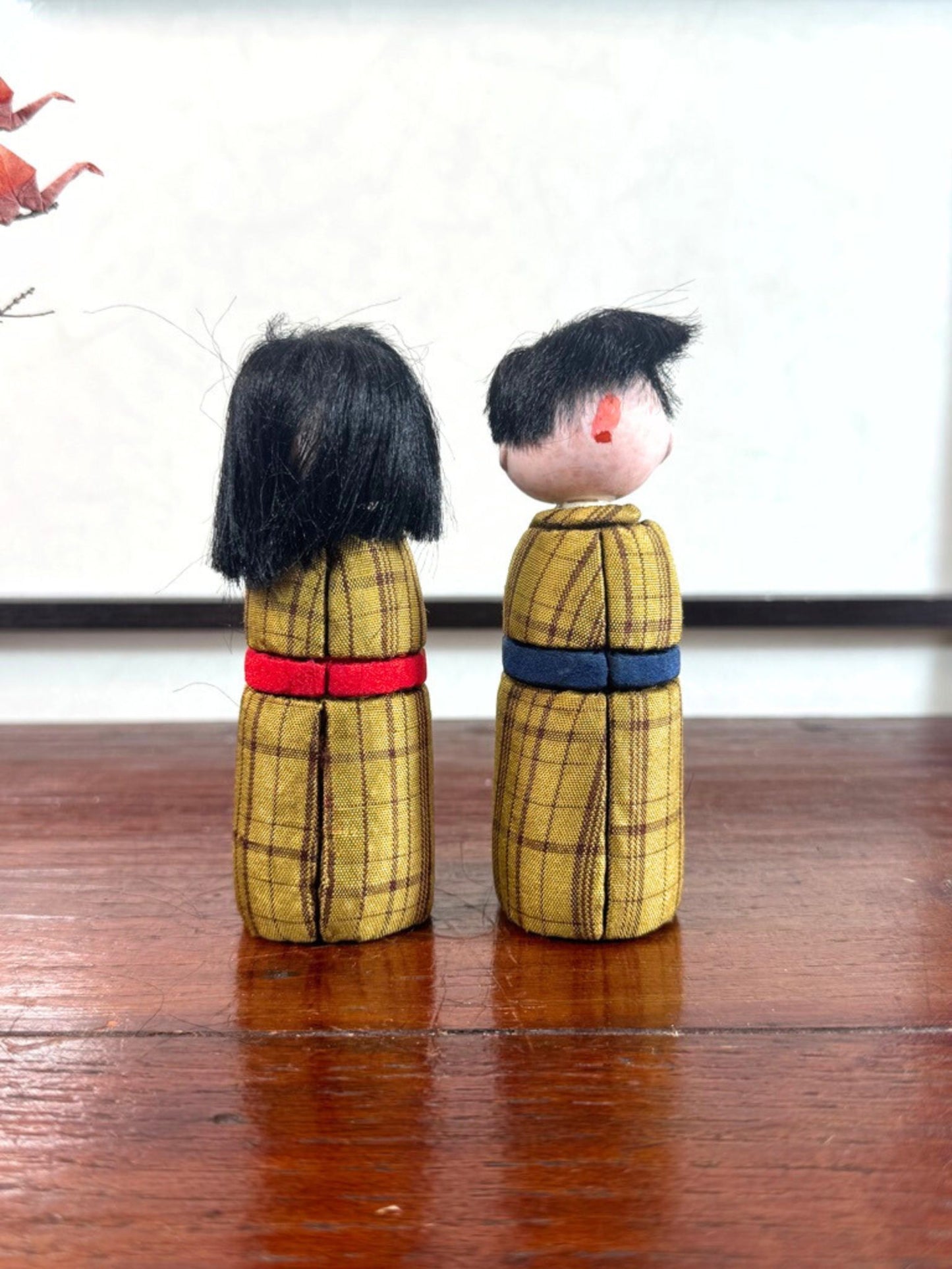 Couple de poupées japonaise kimekomi en kimono jaune, vu de dos