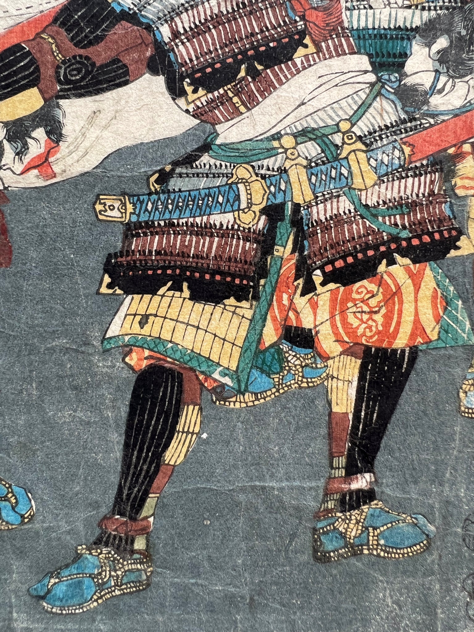 triptyque estampe japonaise samouraï portant des têtes coupées au bout de leurs lances, partie droite détails du bas de l'armure de samouraï, avec sabre