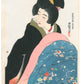 Une femme japonaise en kimono noir se réchauffe sous une couverture florale, assise à un kotatsu, dans une estampe de Itō Shinsui réalisée en 1932, issue d’un rare premier tirage.