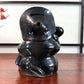 Tirelire tanuki en céramique émaillée noire et crème, style japonais traditionnel, vu de dos
