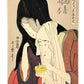 Estampe Japonaise de Utamaro représentant les amants tragiques Koharu et Jihei éteignant la flamme d'une lanterne quelques instants avant de mettre fin à leurs jours ensemble