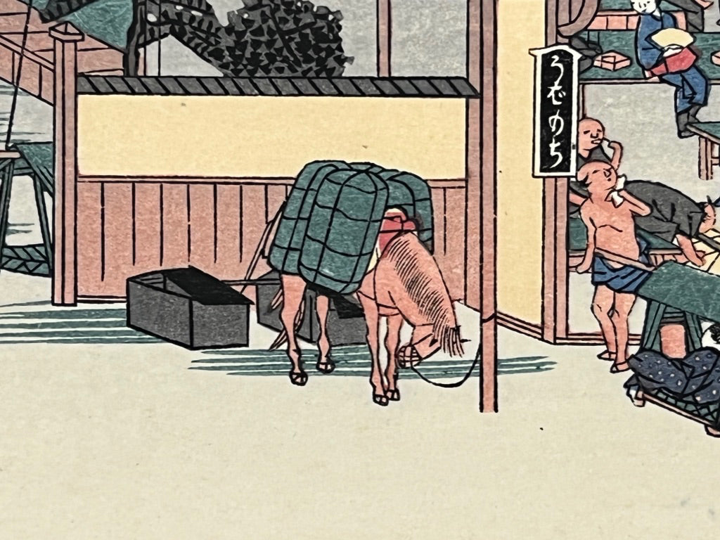 estampe japonaise des porteurs devant une auberge sur la route du Tokaido
