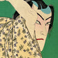 estampe japonaise acteur de théatre levant un sabre, gros plan sur le visage maquillé de l'acteur