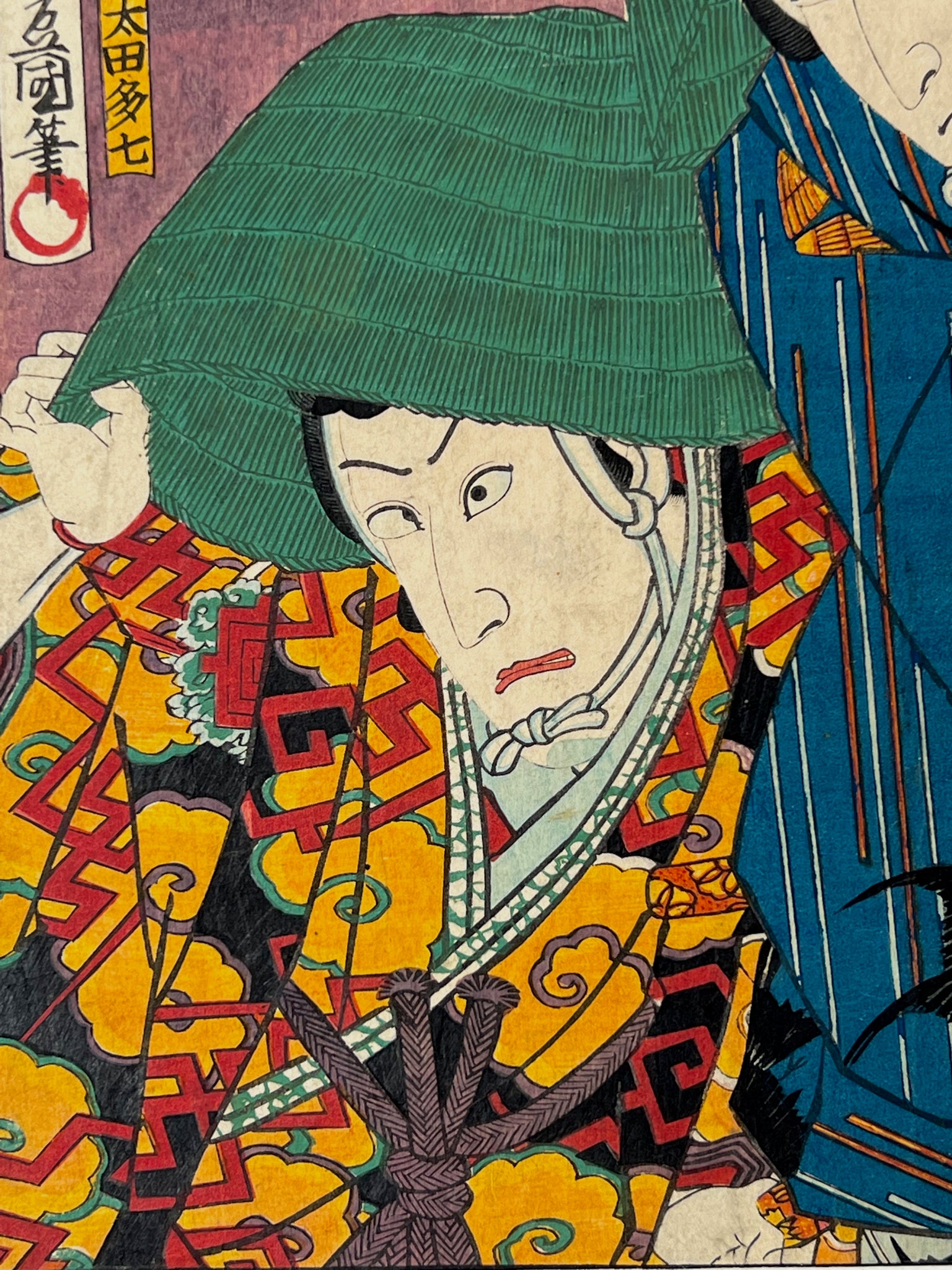 estampe japonaise deux acteurs de kabuki avec chapeaux vert, gros plan sur le visage de l'autre acteur